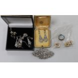 A small group of white metal and paste set jewellery, including a double clip brooch, necklace and