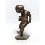 A bronze cherubic boy, signed J. Kostiak, 26cm high