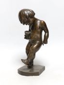 A bronze cherubic boy, signed J. Kostiak, 26cm high