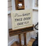 A beech artist's easel, height 170cm, with a door shutting sign *Please note the sale commences at