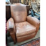 A contemporary tan leather reclining armchair with integral footrest, width 92cm, height 104cm *