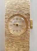 A lady's 9ct gold Buech Girod manual wind bracelet watch, 16.3cm, gross weight 25.3 grams,
