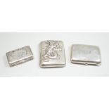 A white metal cigarette case, with applied dragon, 82mm, one other silver cigarette case and a
