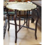 A Chinese brass tray topped hongmu folding occasional table, diameter 56cm *Please note the sale