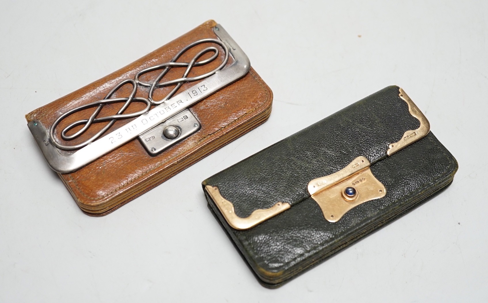 A late Victorian 15ct gold mounted leather purse, 10.3cm and a later silver mounted leather purse.