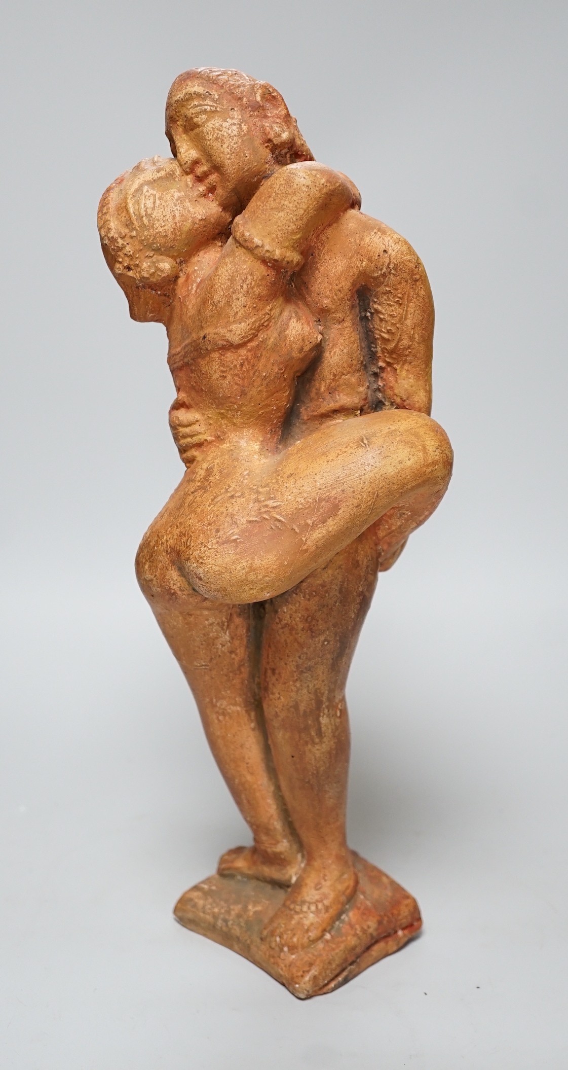 A painted plaster figure of an embracing Indian couple, 37cm tall