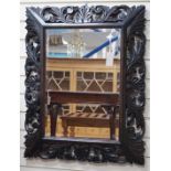 An Edwardian foliate carved oak wall mirror, width 81cm, height 64cm *Please note the sale commences