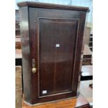 A George III oak hanging corner cupboard, width 69cm, depth 40cm, height 97cm *Please note the