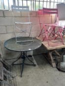 A circular metal and wrought iron garden table, diameter 90cm and three chairs *Please note the sale