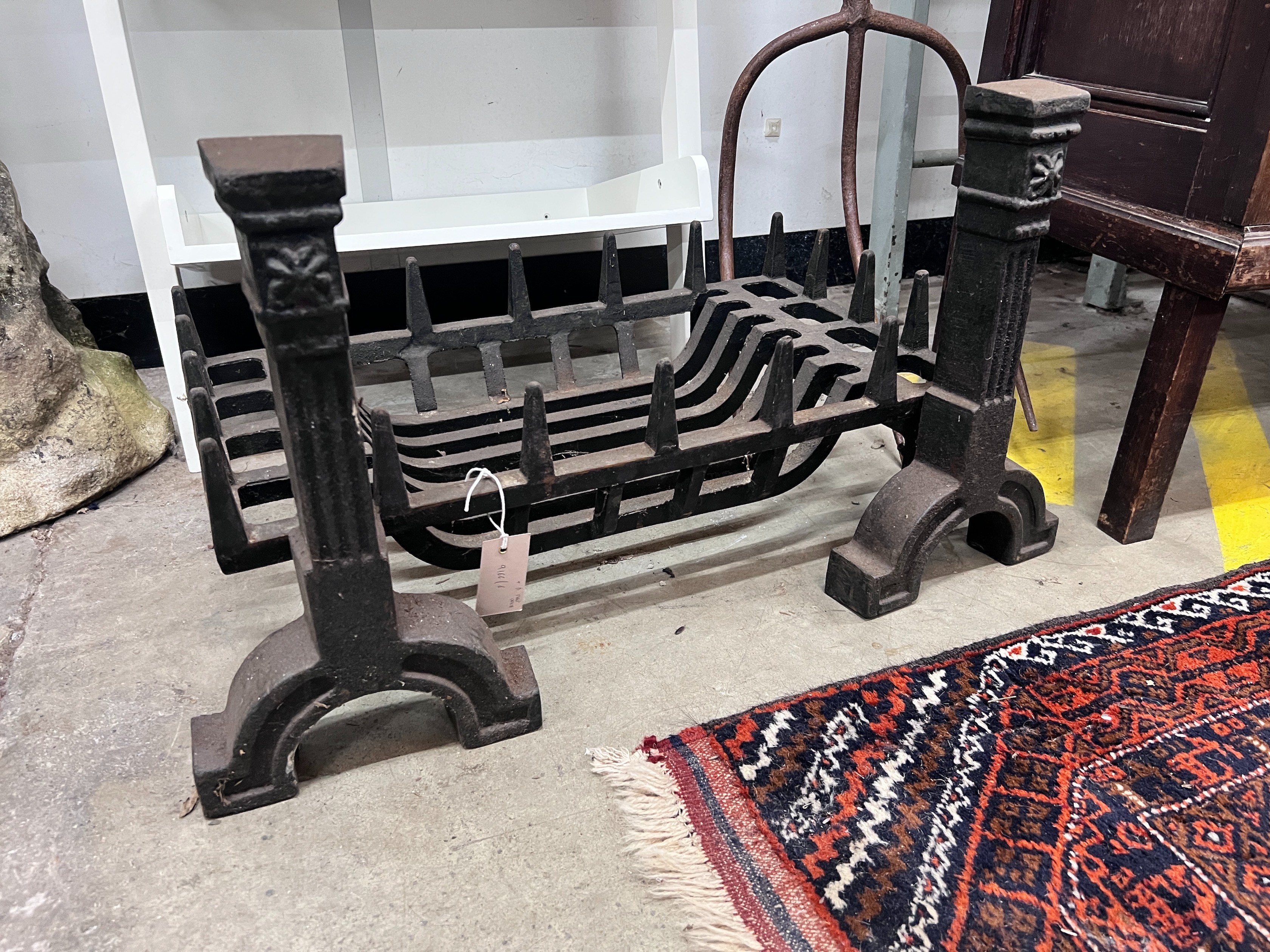 A cast iron fire grate, length 61cm, depth 33cm and a pair of fire dogs *Please note the sale