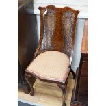 An Edwardian mahogany nursing chair and a 1930's caned walnut occasional chair *Please note the sale