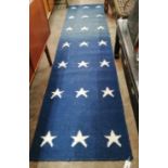 A contemporary wool runner with star motifs, 300 x 76cm *Please note the sale commences at 9am.