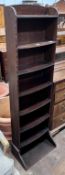 A 1920's oak narrow eight shelf open bookcase, width 49cm, depth 30cm, height 161cm *Please note the