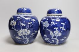 Two Chinese export porcelain Prunus blossom jars and covers, 20cms high