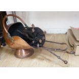 A pair of copper shield shaped fire dogs in Arts & Crafts style, together with further fireside