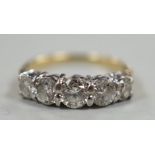 A gold and graduated five stone diamond set half hoop ring, size G/H, gross weight 2.7 grams.