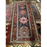 A Caucasian blue ground rug, 231 x 97cm