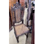 A set of four late 19th century Flemish style carved oak dining chairs with caned seats