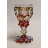 A Bohemian faceted, multicoloured flashed glass goblet, 16cm high