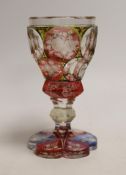 A Bohemian faceted, multicoloured flashed glass goblet, 16cm high