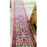 A Persian cream ground runner with central foliate motifs, 400 x 86cm