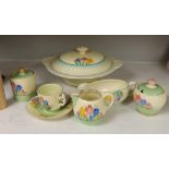 Clarice Cliff ‘Spring Crocus’: a tureen and cover, a cup and saucer, two jam pots, a sauce boat