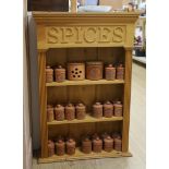 A pine kitchen spice rack with Henry Watson Pottery ‘Original Suffolk Canister’ set