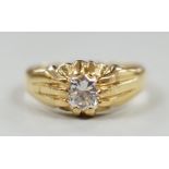 An 18ct and claw set solitaire diamond ring, size W/X, gross weight 7.3 grams.