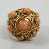 A 20th century yellow metal, coral bead and cannetile work set dress ring, size N/O, gross weight