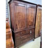 A George III mahogany linen press with two doors enclosing three adjustable shelves, width 125cm,