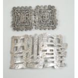 A Chinese white metal belt buckle, 13.3cm wide, the border cast with models of Guangxu cash and a