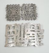 A Chinese white metal belt buckle, 13.3cm wide, the border cast with models of Guangxu cash and a