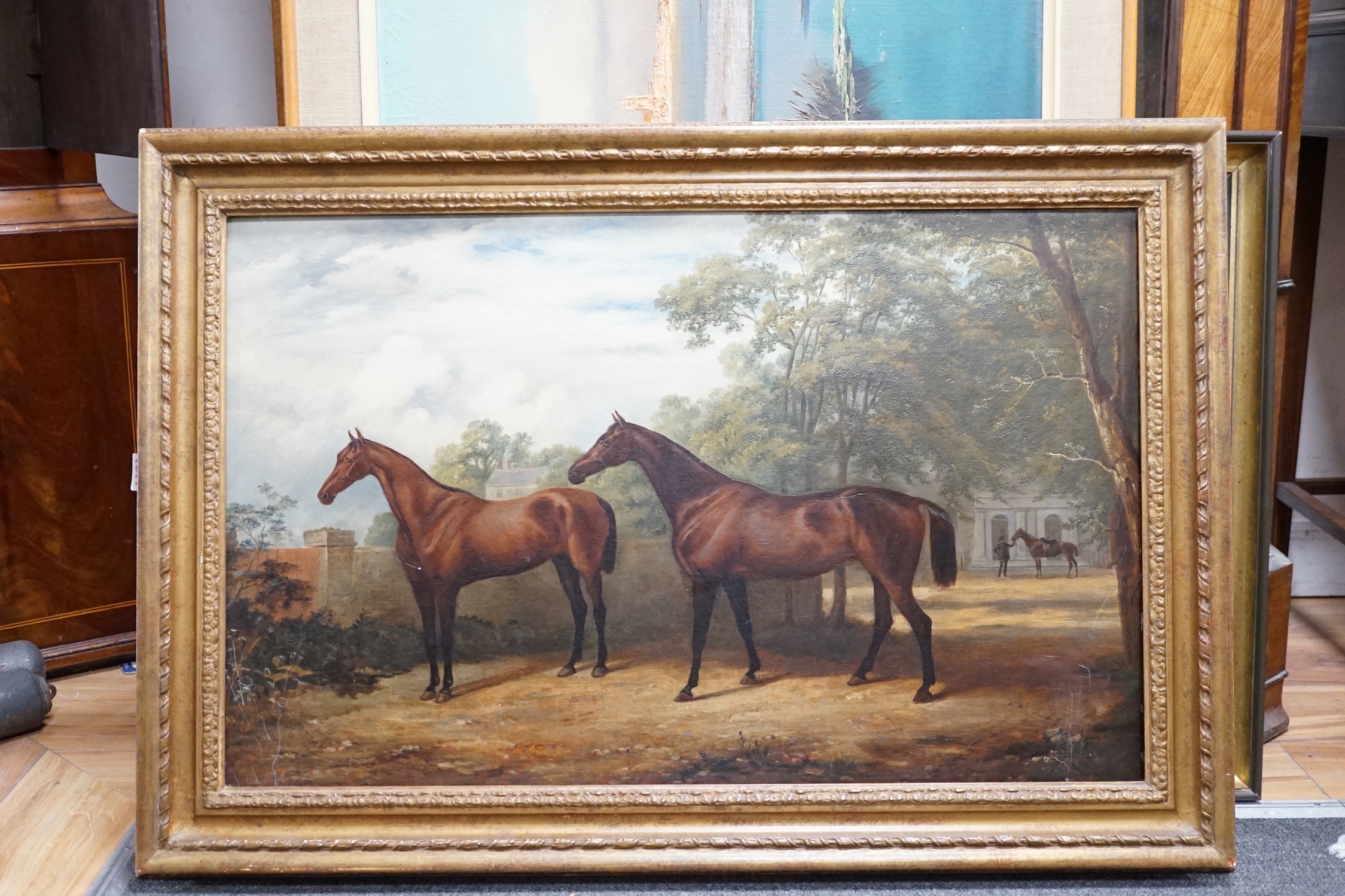 English School c.1900, oil on canvas, Portrait of two racehorses standing in parkland, a groom and - Image 2 of 2