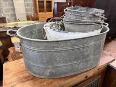 A Victorian galvanised metal wash tub, a white painted pail tub and four assorted buckets, largest
