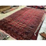 A Persian Bokhara design carpet, 403 x 225cm