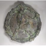 Phoebe Stabler (1879-1955). 'The Piping Faun', a patinated copper covered plaster roundel plaque,