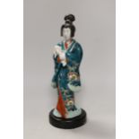 A Japanese Kutani figure of a Geisha and dog