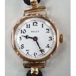 A lady's 1920's 9ct gold Rolex manual wind wrist watch, on associated fabric strap.