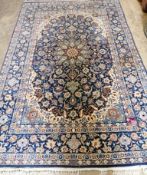 An Iranian silk blue ground carpet with central foliate motifs, 240 x 151cm