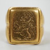 An antique yellow metal signet ring, engraved with crowned rampant lion (tired), size K/L, 14.1