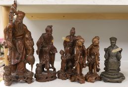 A group of five Chinese carved hardwood figures and another
