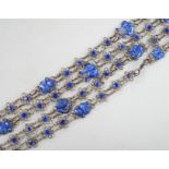 A long Chinese white metal and blue enamel set drop necklace, 204cm.