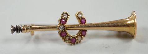 An Edwardian yellow metal, ruby and diamond set hunting horn and horseshoe brooch, 37mm, gross