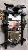 A late 19th century Black Forest ebonised oak wall mirror with eagle surmount, width 46cm, height
