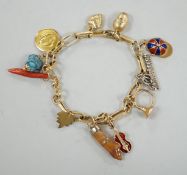 A modern Italian yellow metal charm bracelet, hung with eleven assorted charms, including 750 and