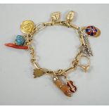 A modern Italian yellow metal charm bracelet, hung with eleven assorted charms, including 750 and