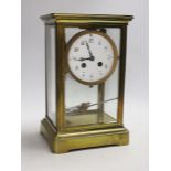 An early 20th century brass four-glass clock with mercury pendulum, 28cm high