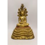 A large Thai gilt bronze seated figure of Buddha on a naga throne, 43cm high