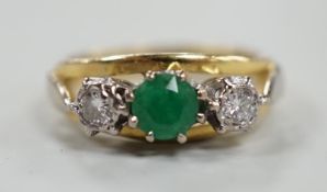 A modern yellow metal, emerald and diamond set three stone ring, size G, gross weight 3.8 grams.