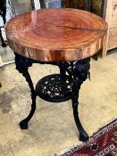 A resin encased cedar wood occasional table with cast iron underframe, diameter 53cm